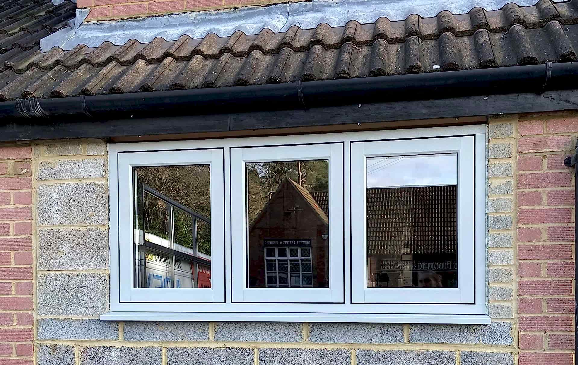 Triple-panel window reflecting opposite building | D2R Windows