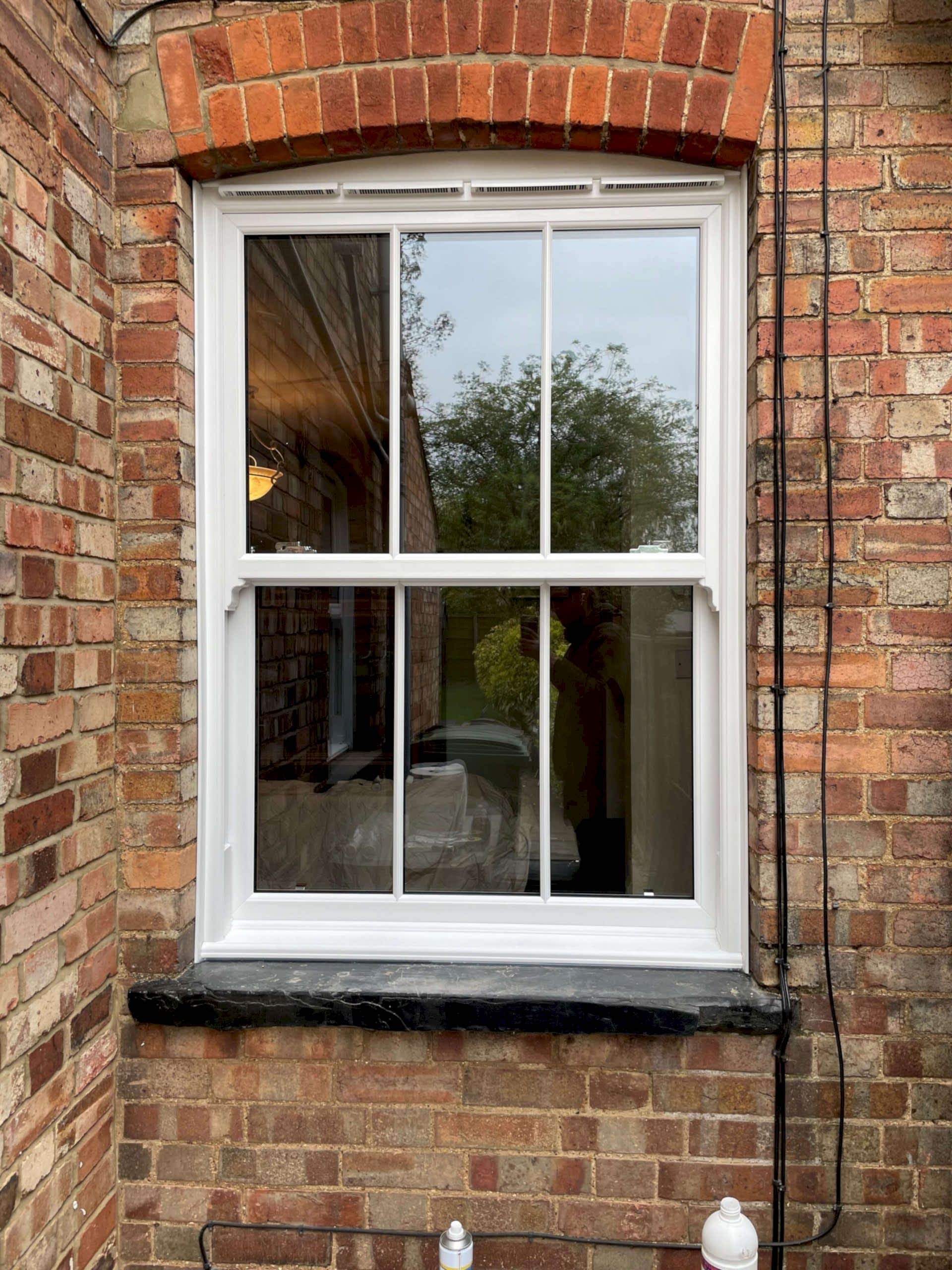 Modern living room with large windows, stylish furniture & light